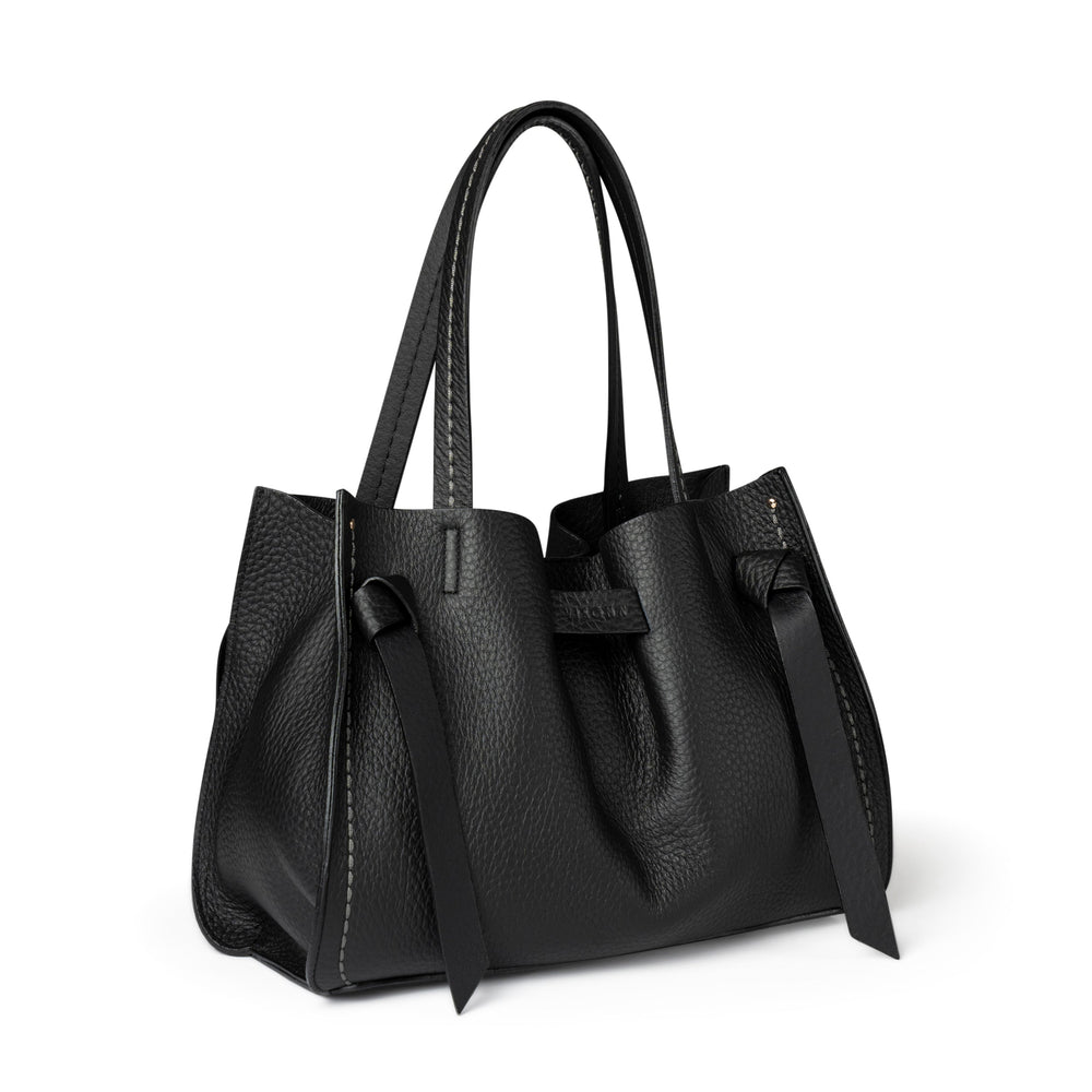 Black handbag with bow detail on a white background
