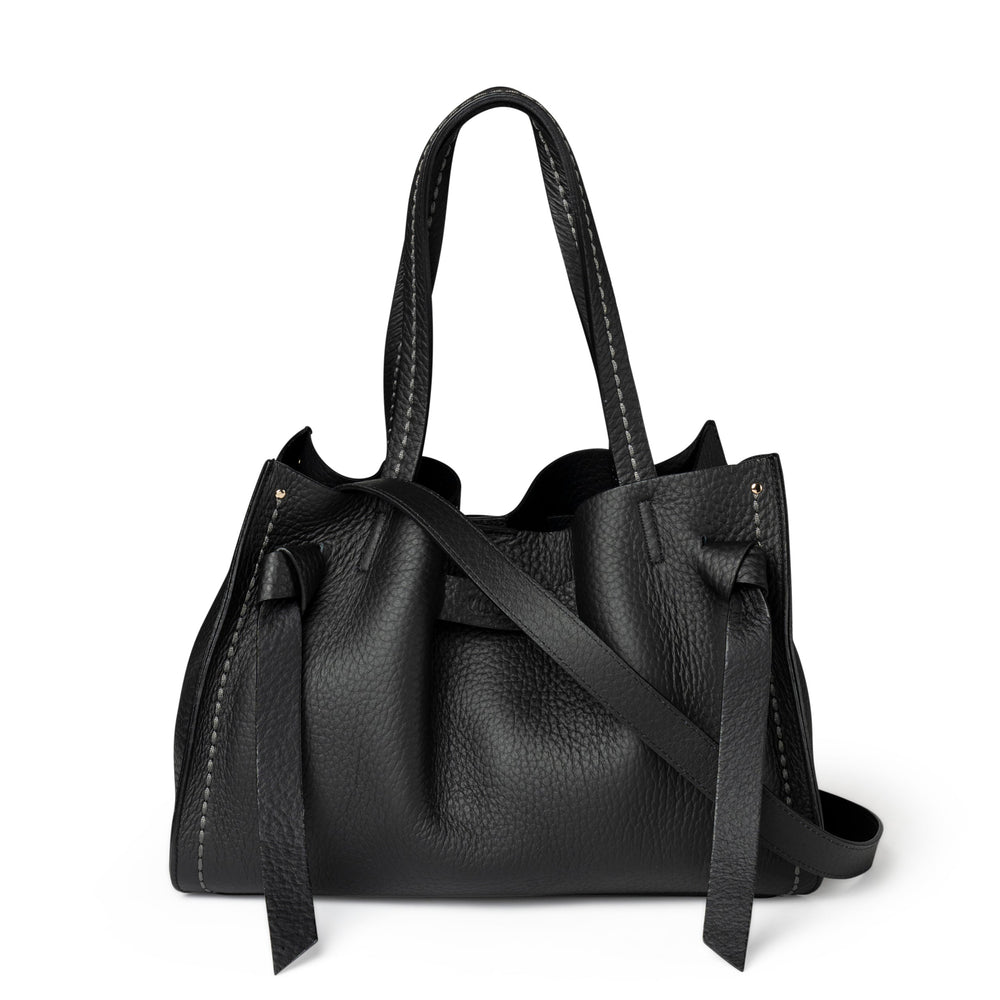 Black leather handbag with a strap on a white background