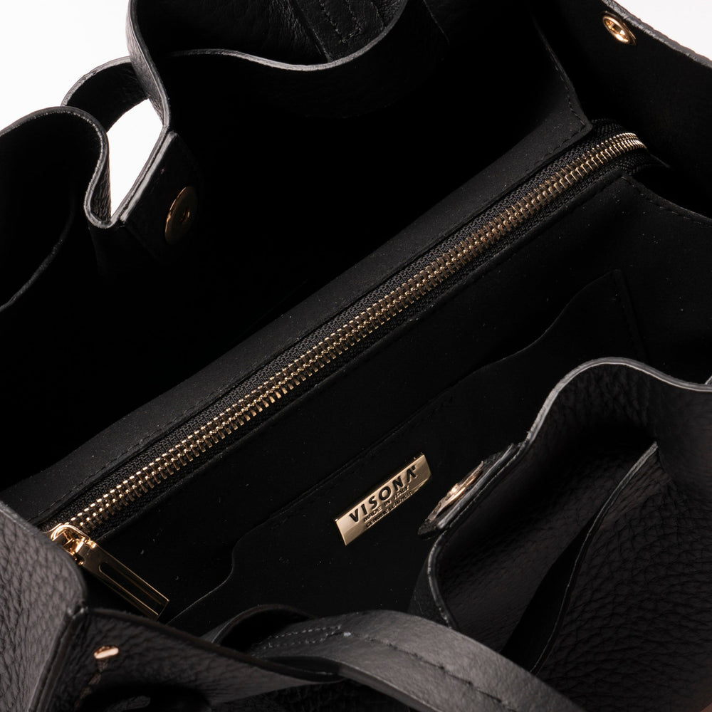Black handbag with gold zipper and visible brand logo on a white background