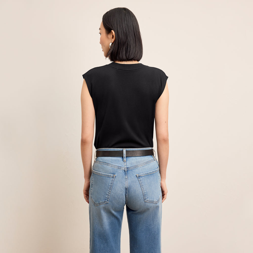 Back image of a woman standing wearing the alina top in compact cotton in black