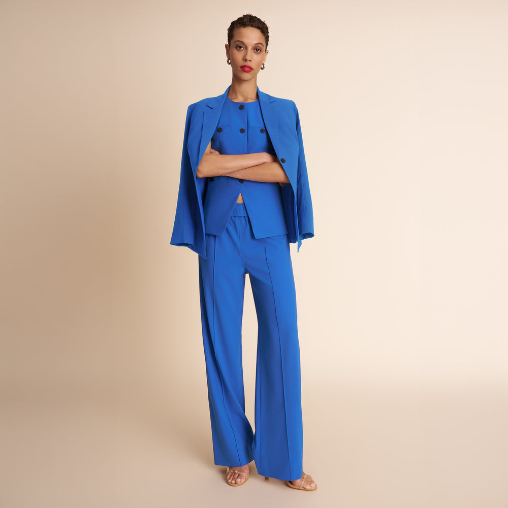 Woman wearing a blue suit on a beige background