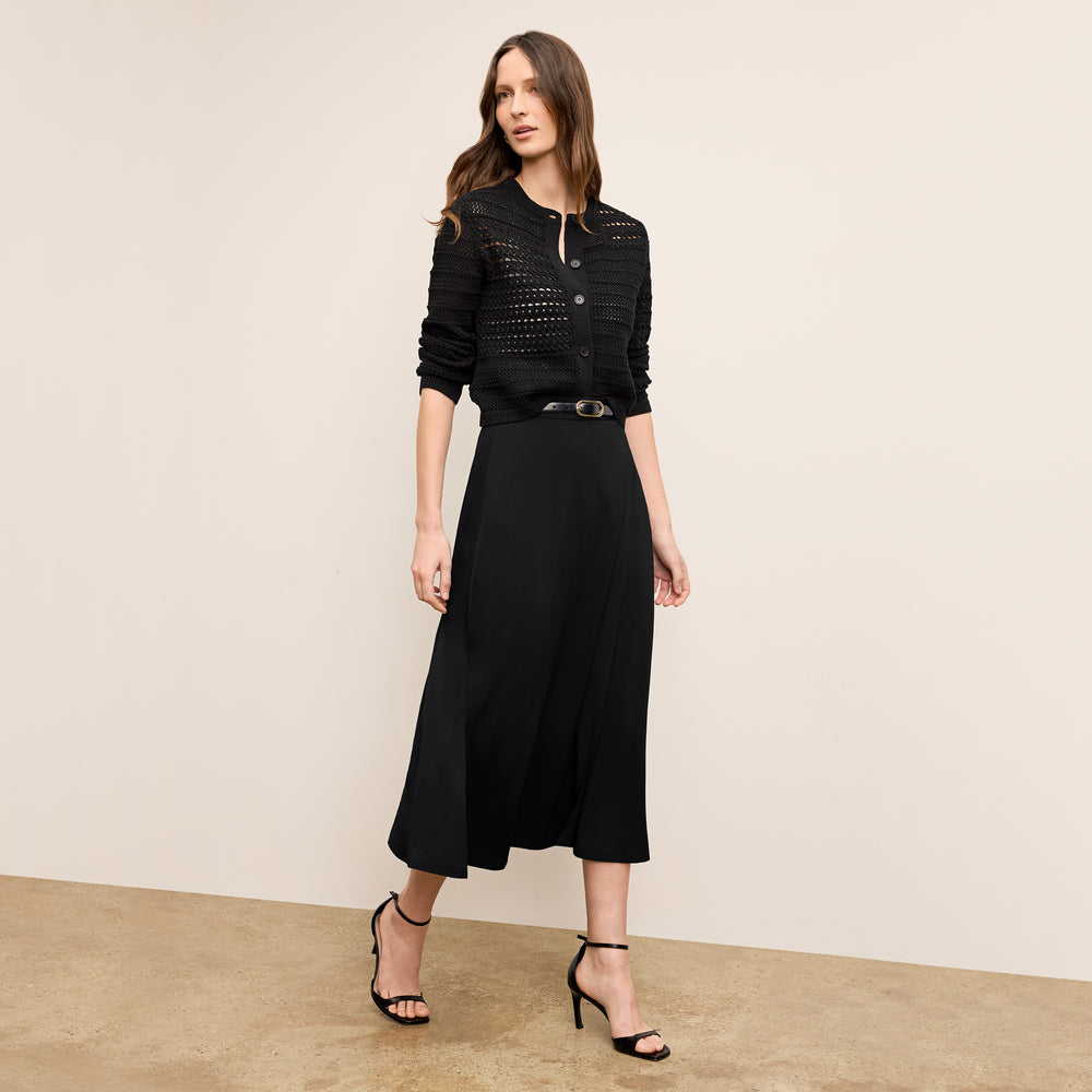 Front image of a woman wearing the zosia cardigan in black