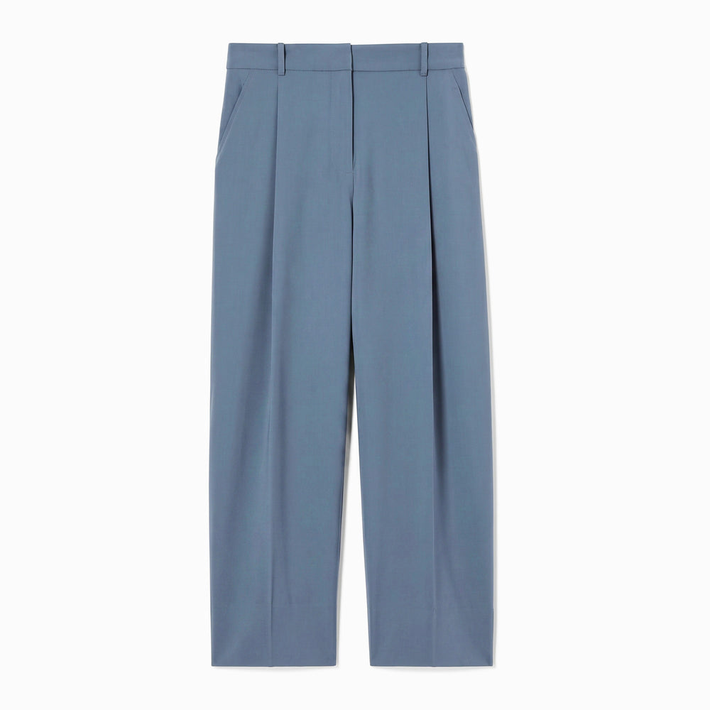 A pair of high-waisted, wide-leg trousers in a dusty slate blue color, featuring front pleats and belt loops, shown flat against a white background.