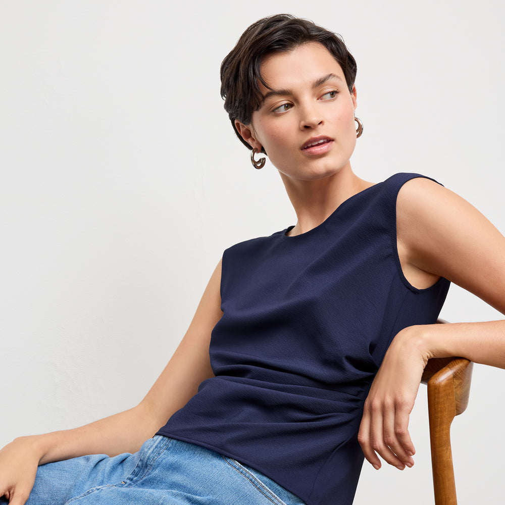 front image of a woman wearing the brooke top in soft navy