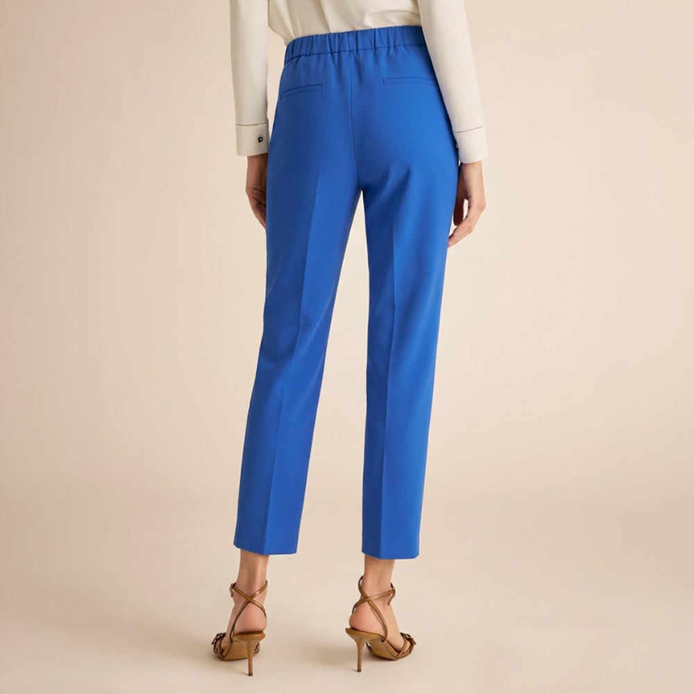 Blue pants worn by a person on a beige background