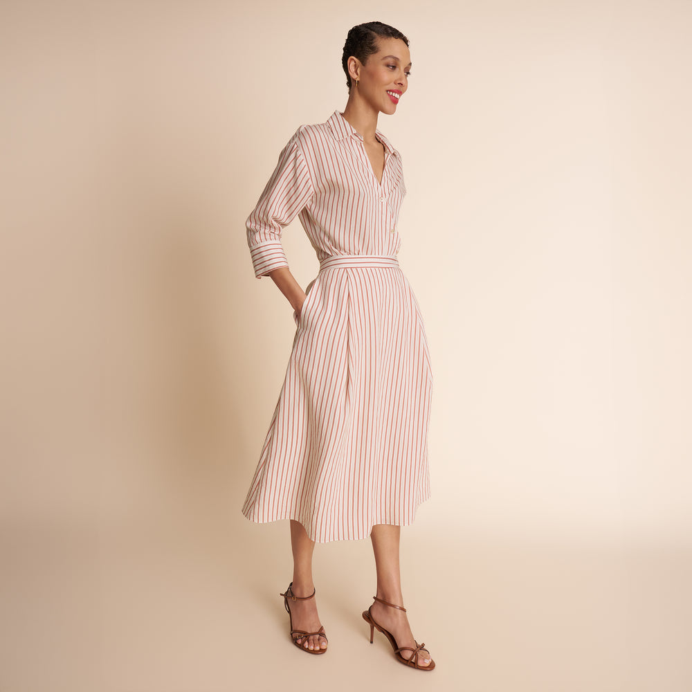 woman in stripped shirt and skirt.