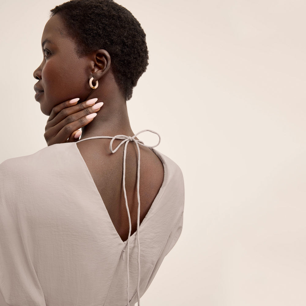 Back image of a woman wearing the Jelina Dress in Quartz Voile