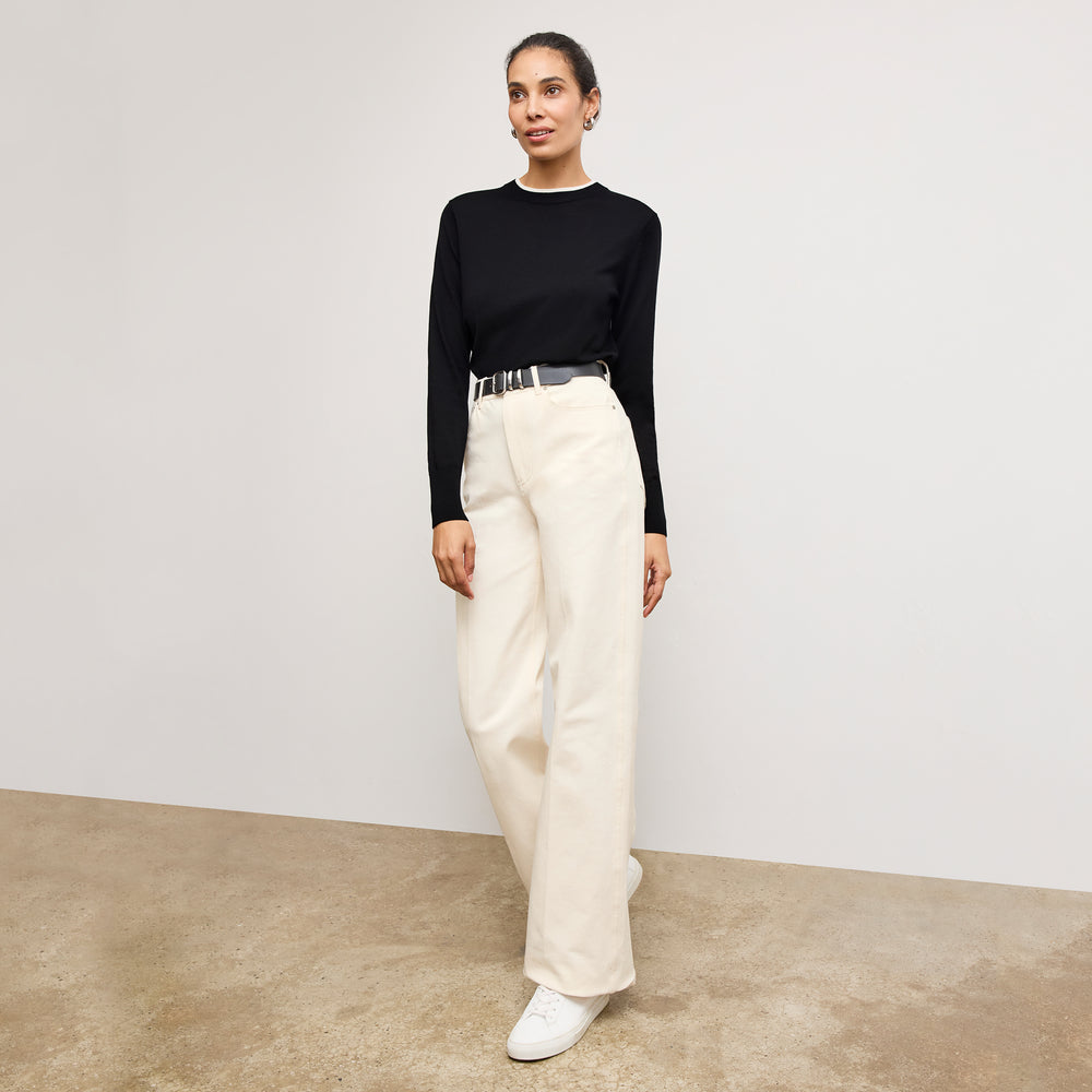 front image of a woman wearing the kit sweater in black/ivory