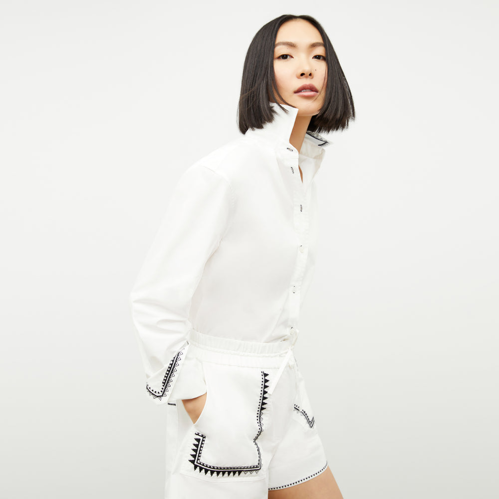 front image of a woman wearing the mila button down in white