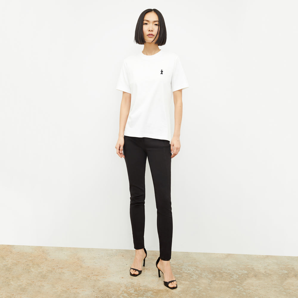 front image of a woman wearing the leslie t-shirt embroidered in white