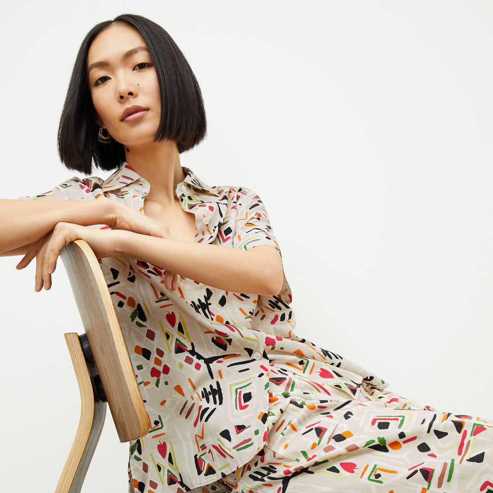front image of a woman wearing the livingston top in rhythm print