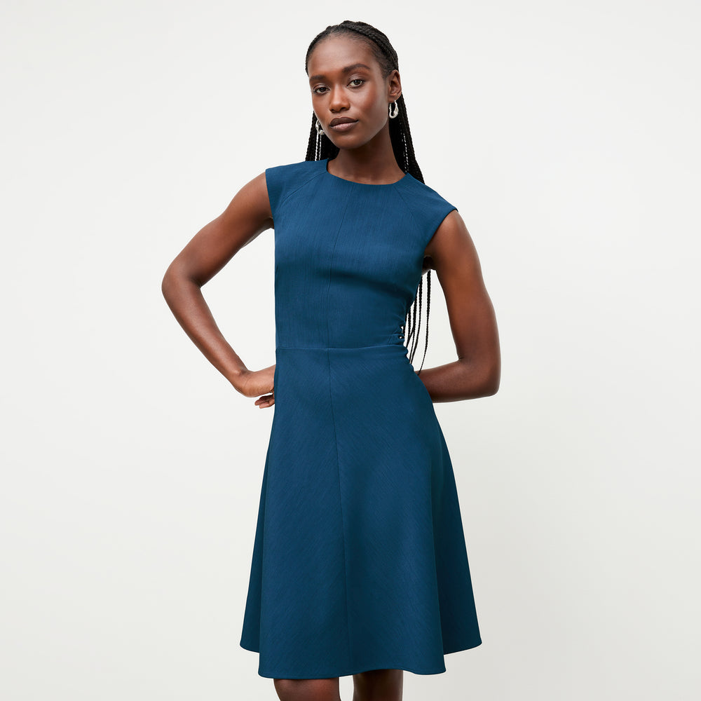 front image of a woman wearing the toi dress deep teal