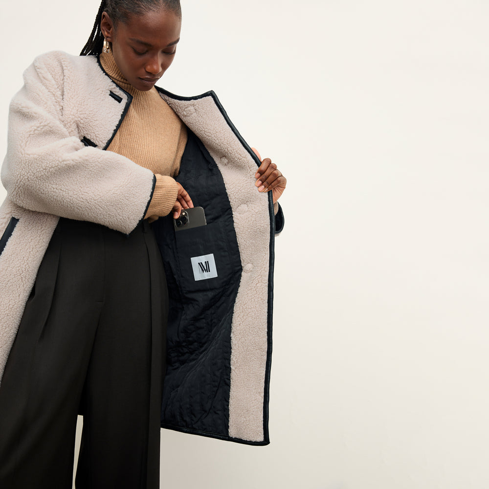 front image of a woman wearing the katari jacket in travertine