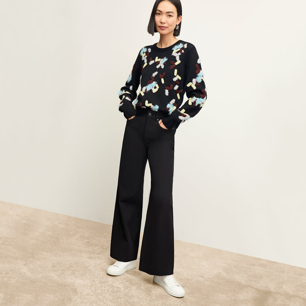 front image of a woman wearing the tish sweater in confetti