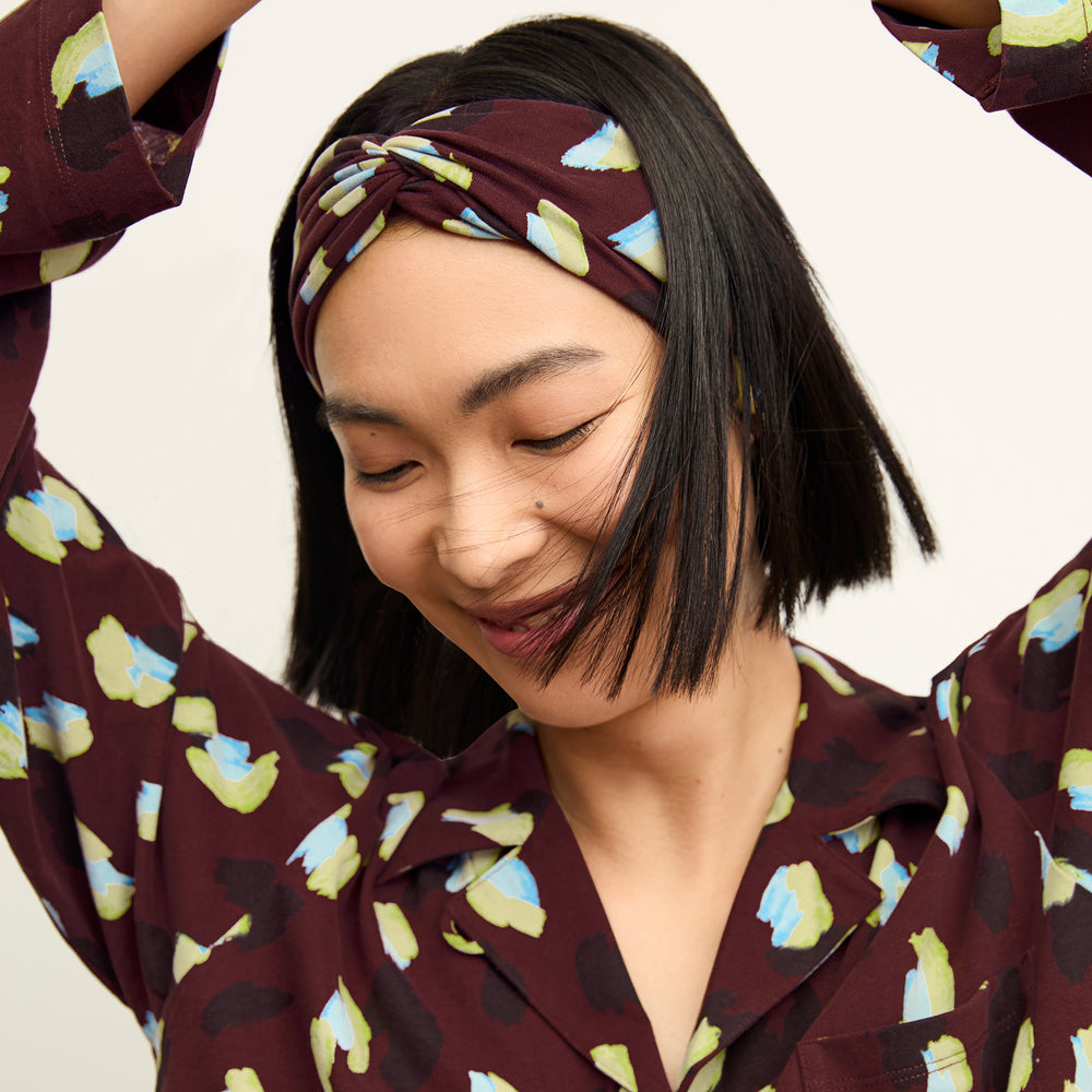 front image of a woman wearing a headband in bengal print