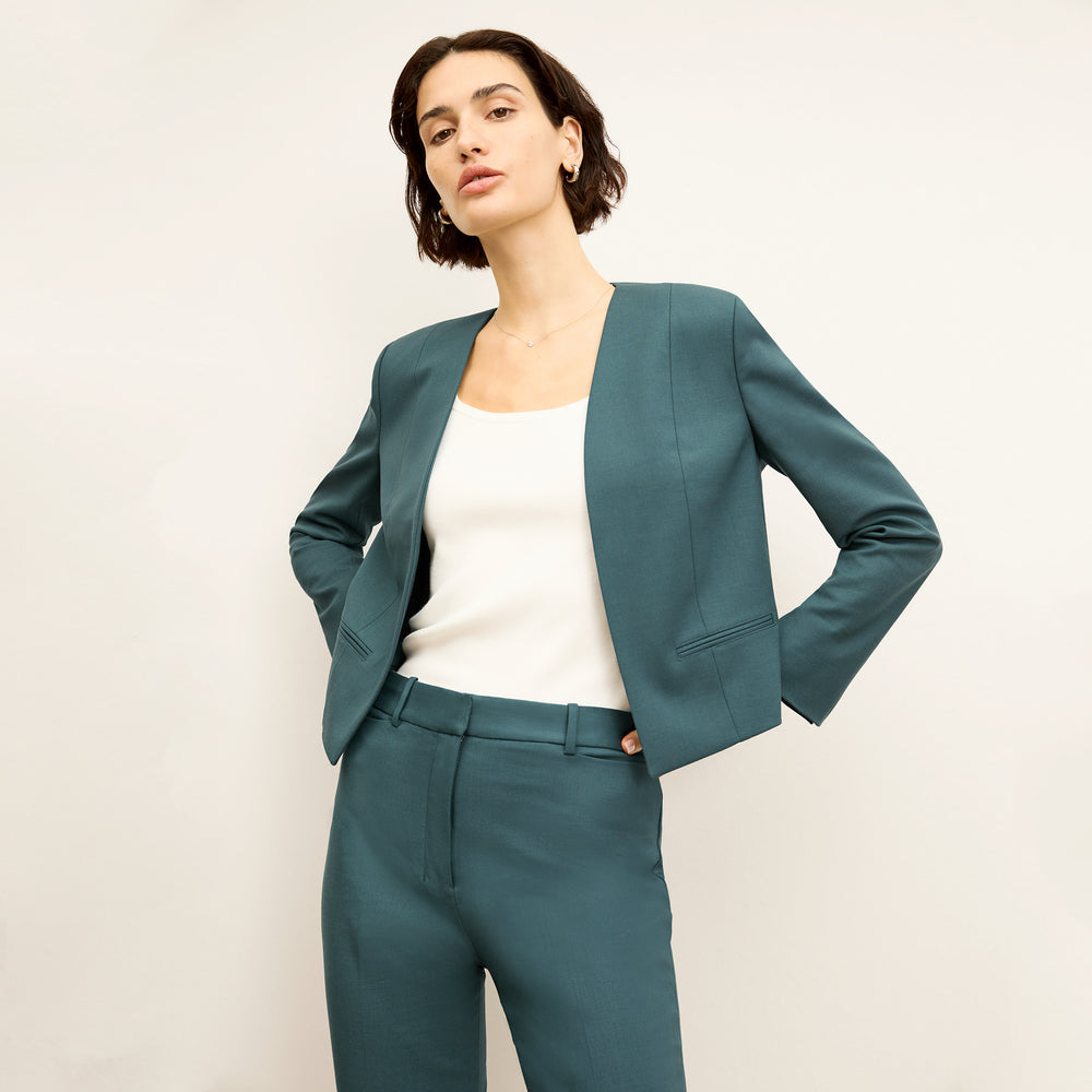 front image of a woman wearing the neale jacket in blue jade