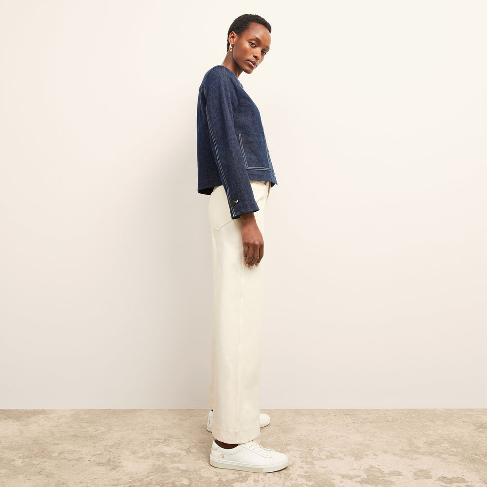 side image of a woman wearing the kane jacket in dark wash