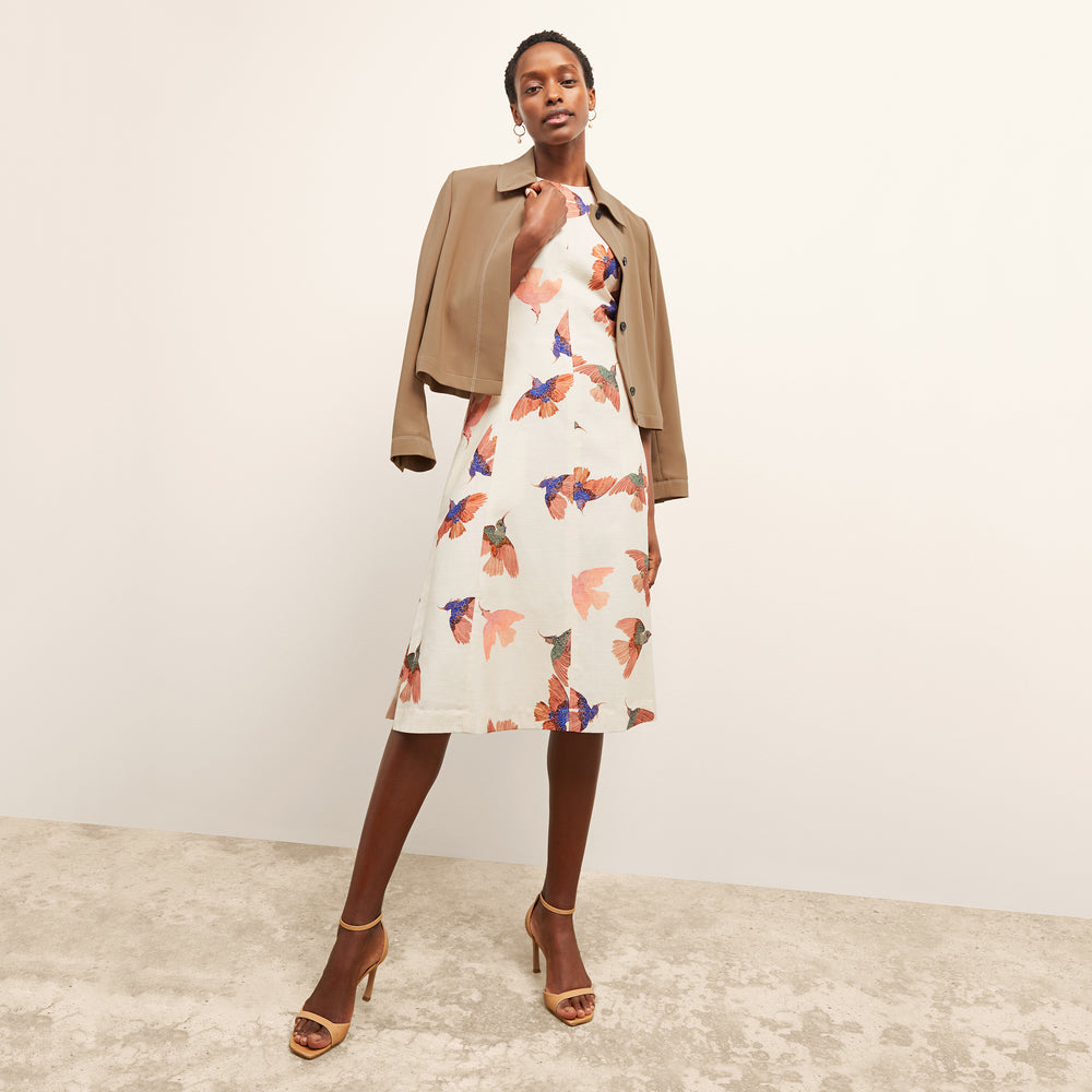 front image of a woman wearing the estela dress in hummingbird print