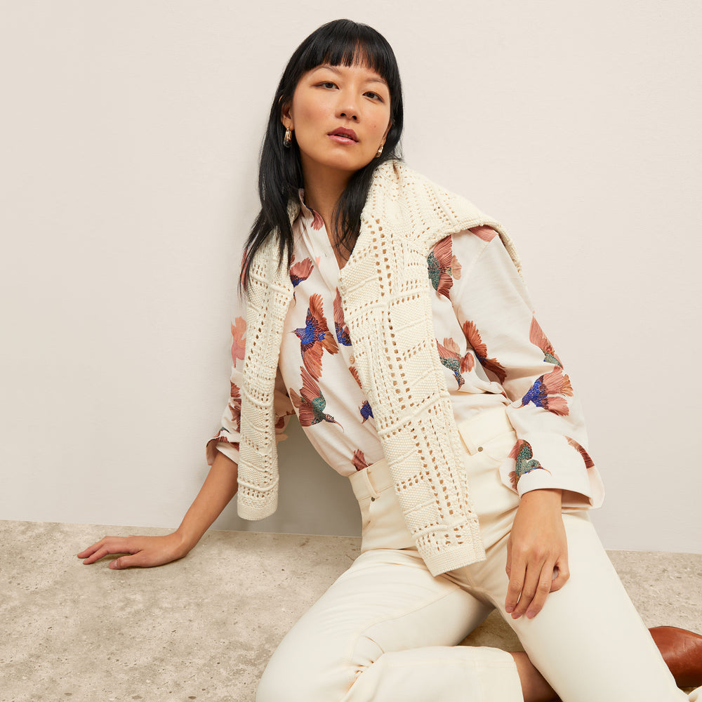 front image of a woman wearing the mila top in hummingbird print