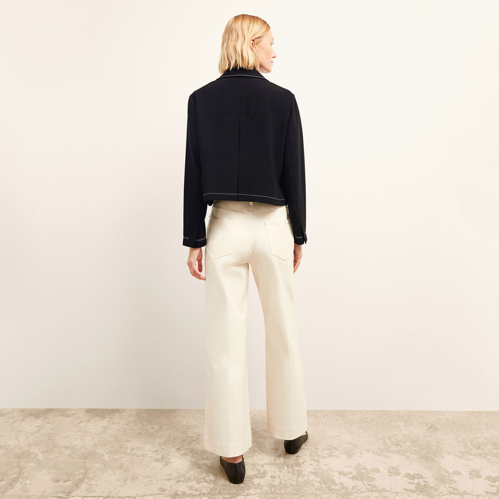 back image of a woman wearing the nicky jacket in black