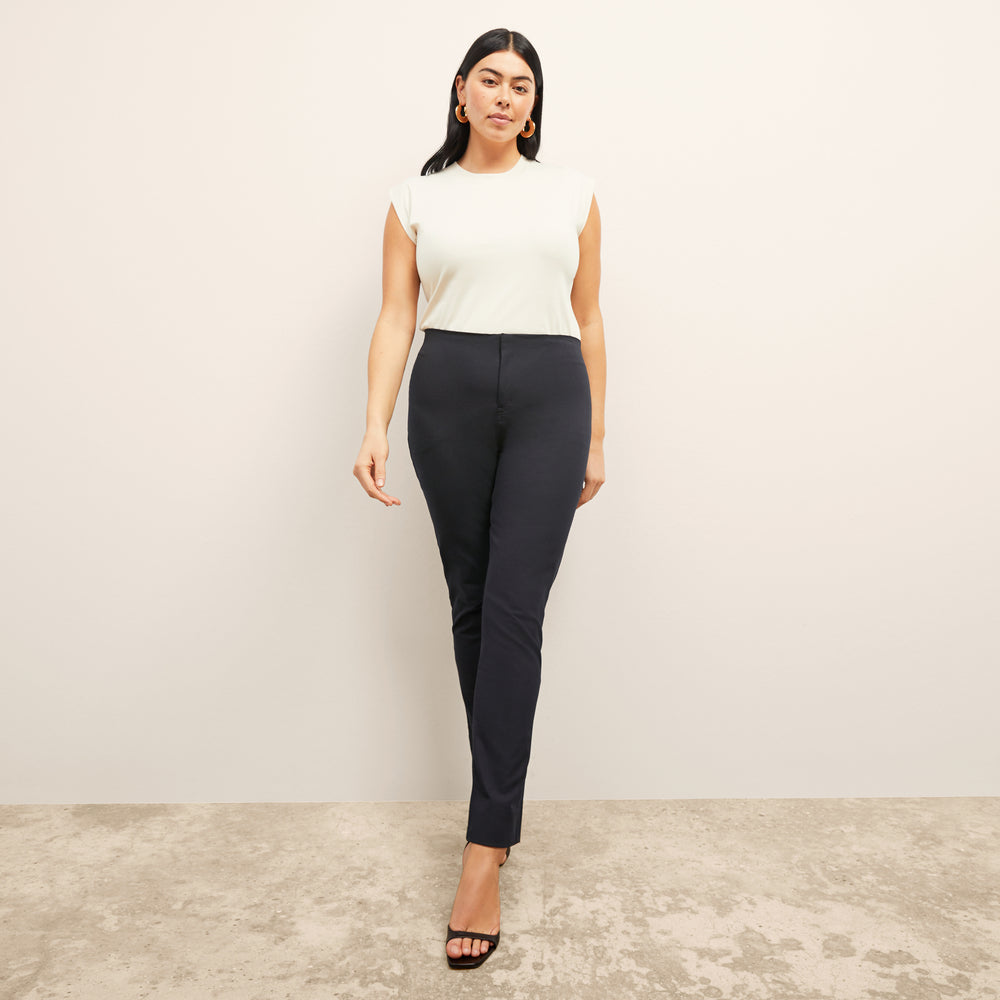 Front image of a woman standing wearing the alina top in compact cotton in ivory