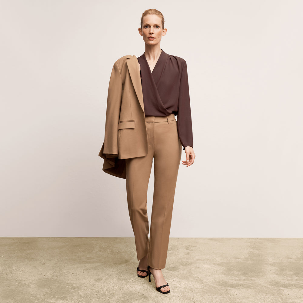 Front image of a woman wearing the smith in camel