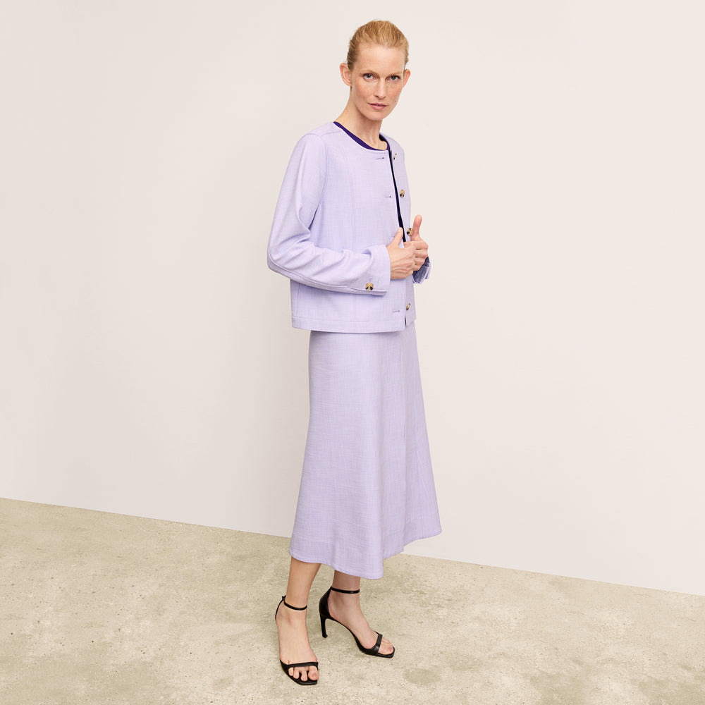 front image of a woman wearing the aniya jacket in lilac/ivory