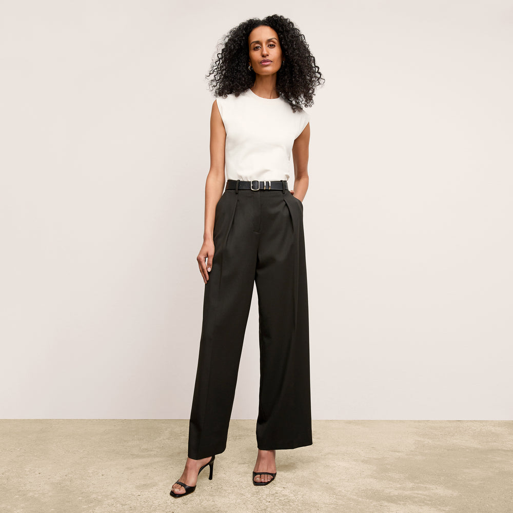 Front image of a woman standing wearing the alina top in compact cotton in ivory