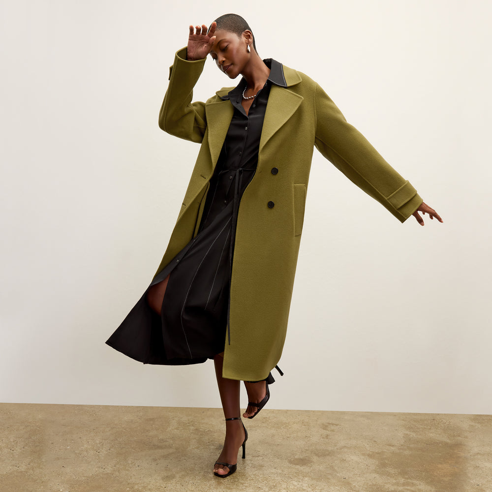 front image of a woman wearing the viola coat in pistachio