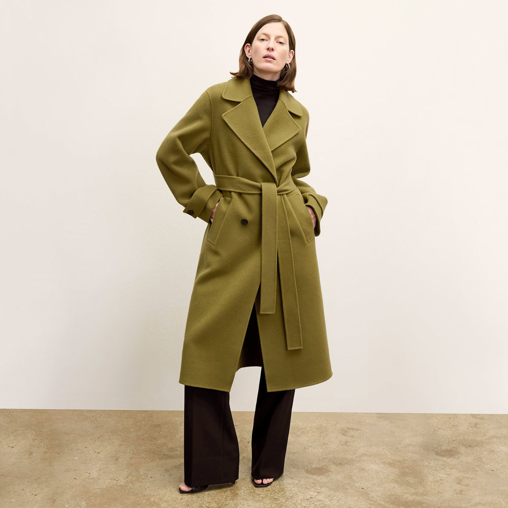 front image of a woman wearing the viola coat in pistachio