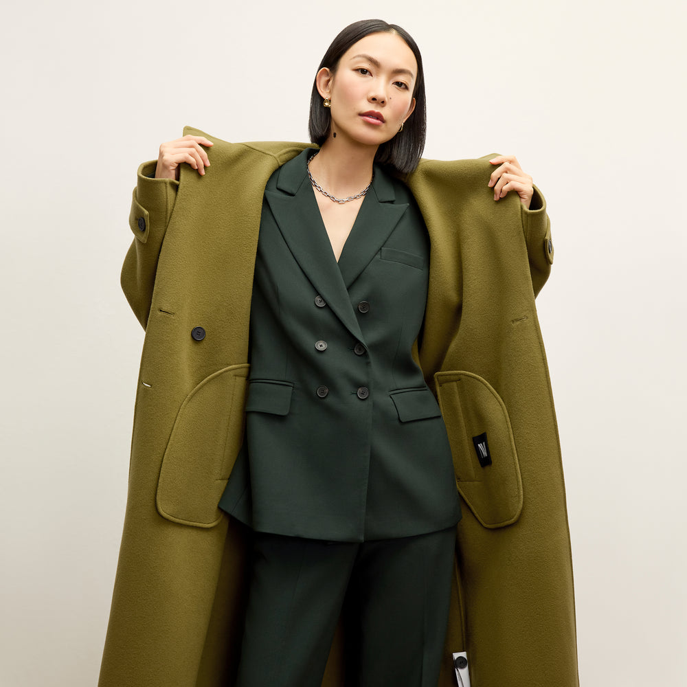 front image of a woman wearing the kati jacket in dark emerald