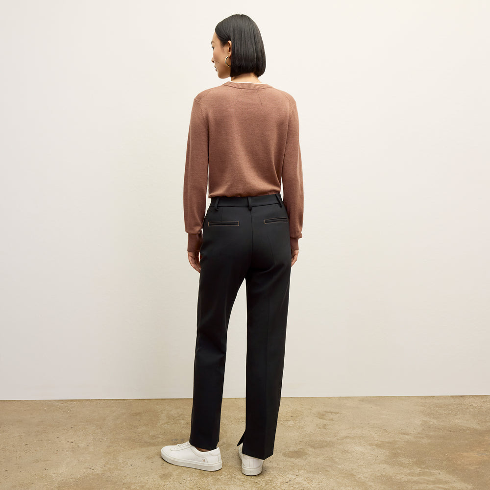 back image of a woman wearing the kit sweater in camel/ivory