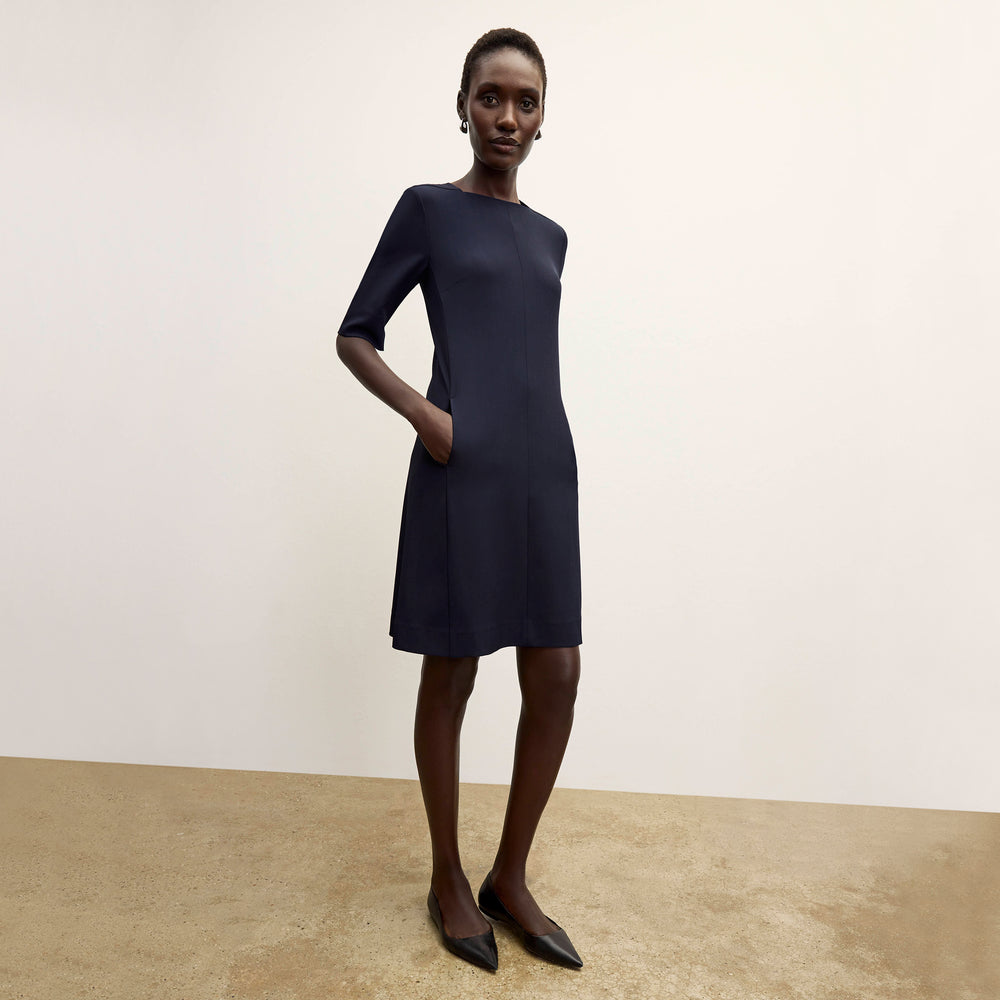Front image of a woman wearing the Emily Dress in dark navy