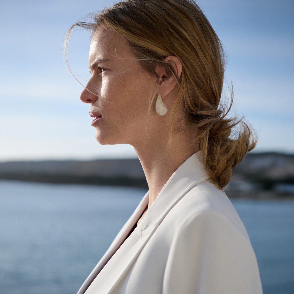 Women wearing white earrings