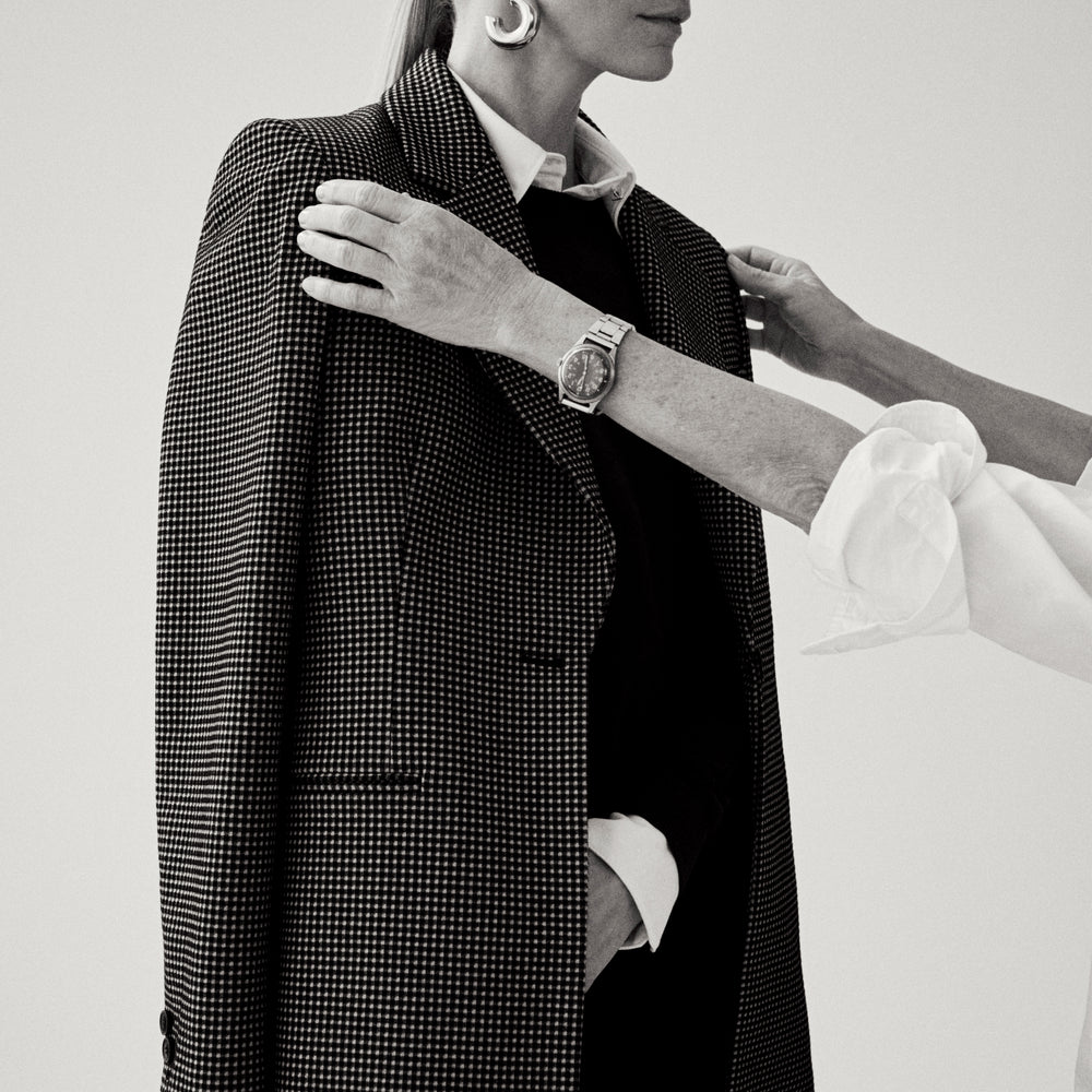 image of a woman adjusting a blazer on her client