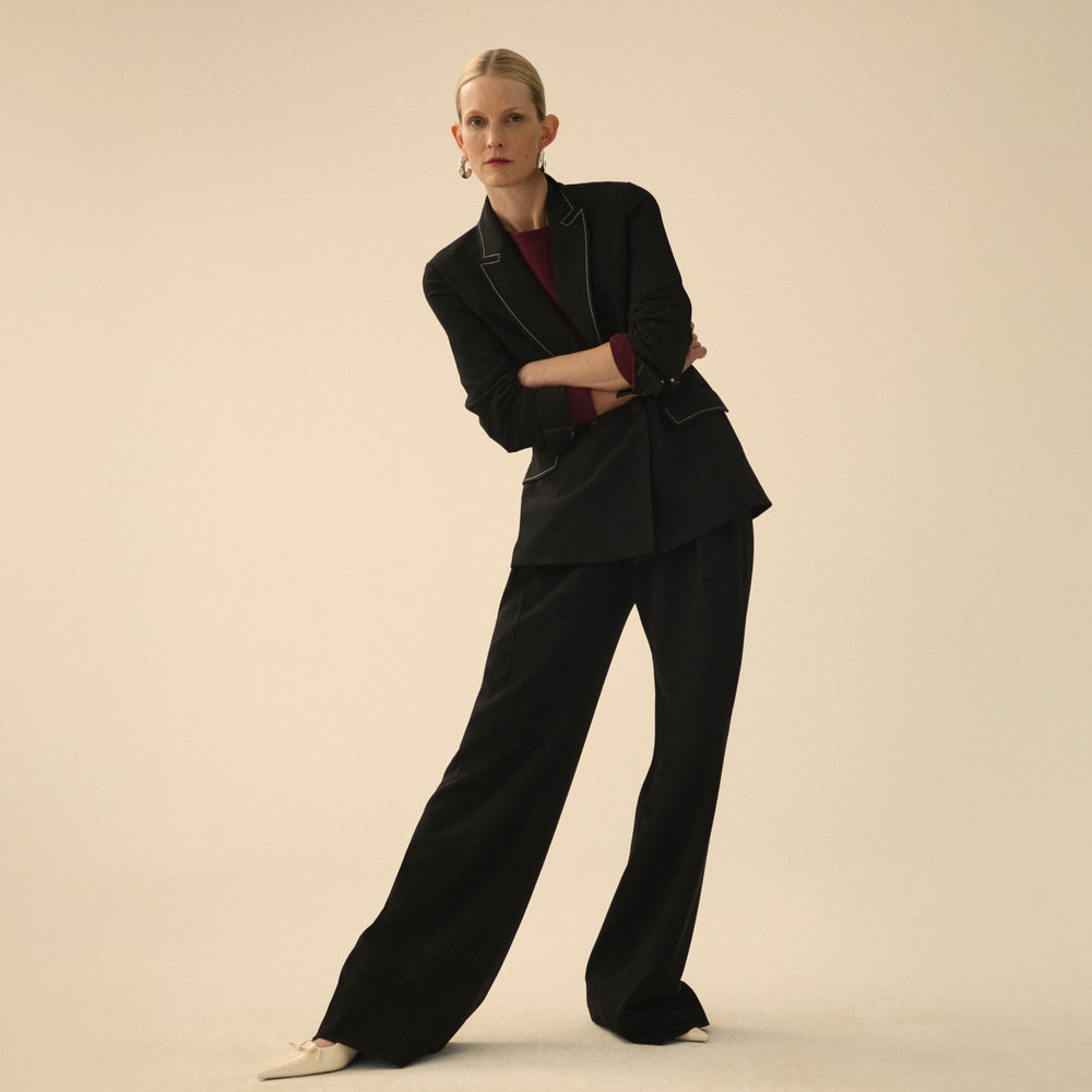 front image of a woman wearing the o'hara jacket in black with topstitch