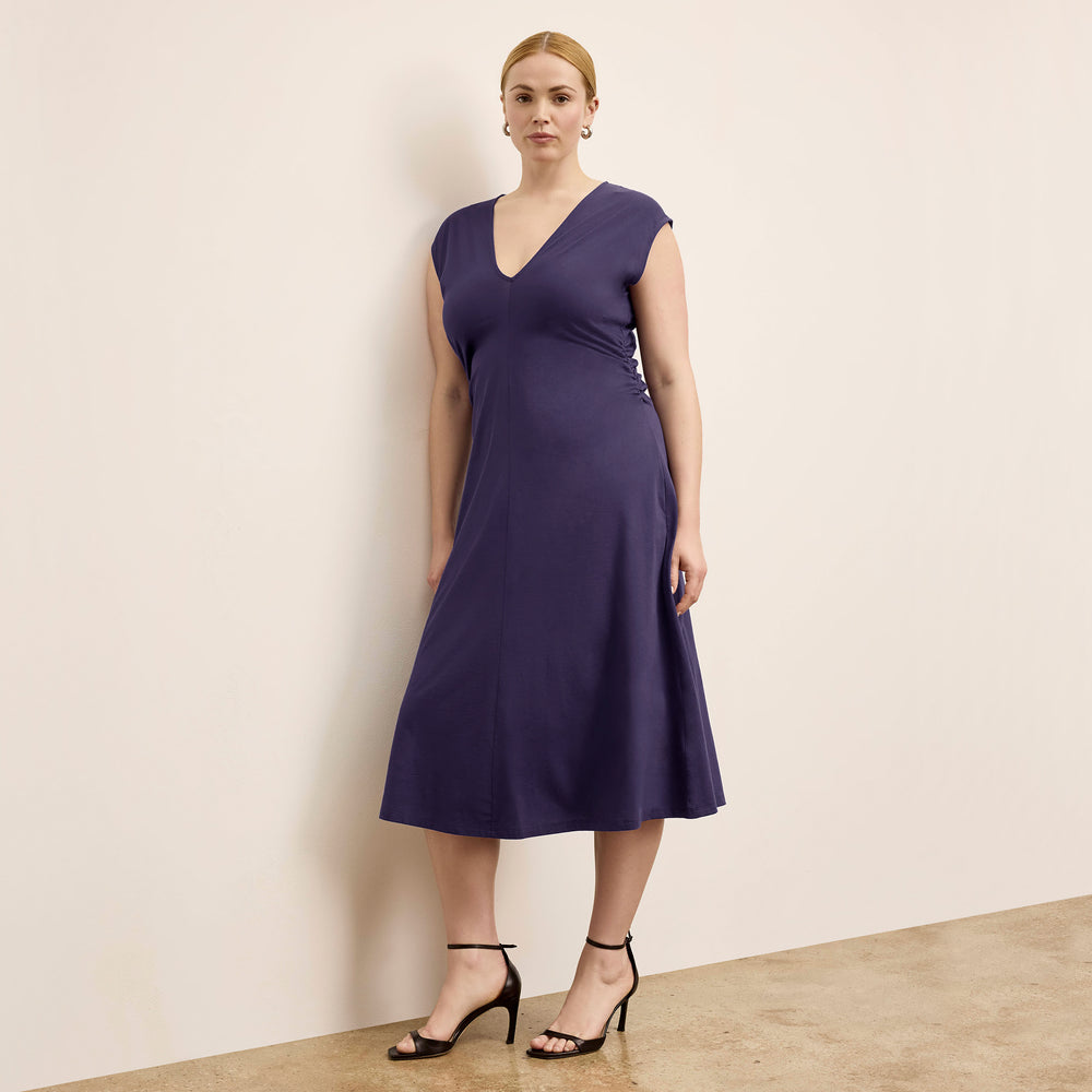 front image of a woman wearing the marina dress in deep iris