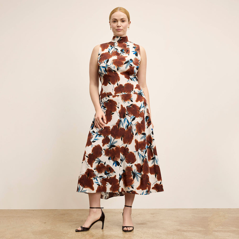 Woman wearing a floral dress with a neutral background