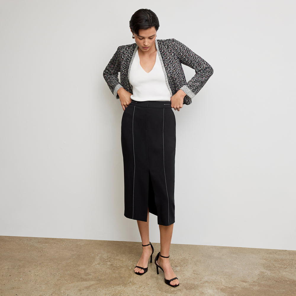 front image of a woman wearing the meena jardigan in boucle tweed black/white
