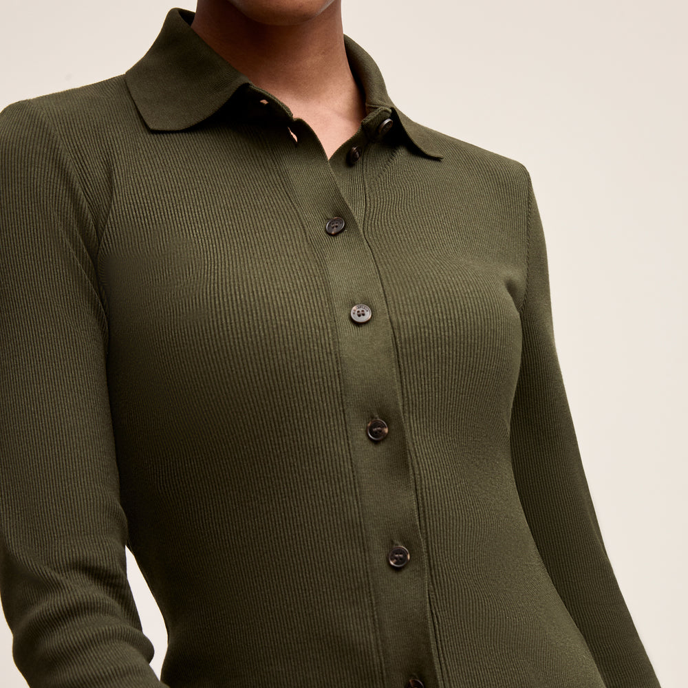 Green button-up shirt with a collar on a neutral background