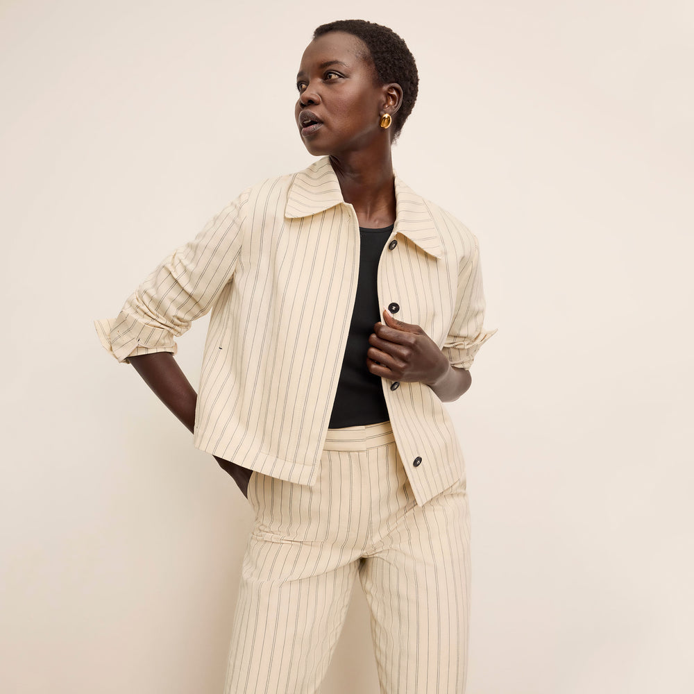 front image of a woman wearing the nicky jacket in linen stripe