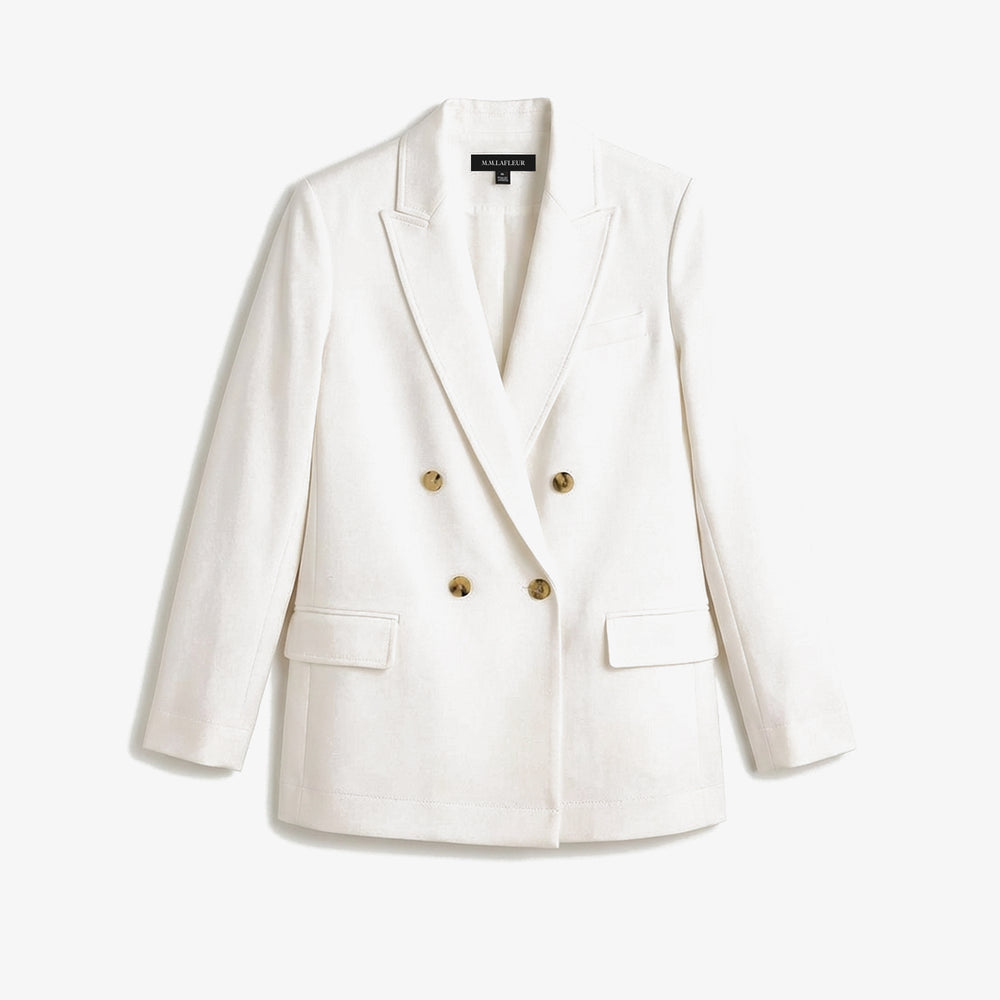 White blazer with gold buttons on a light gray background