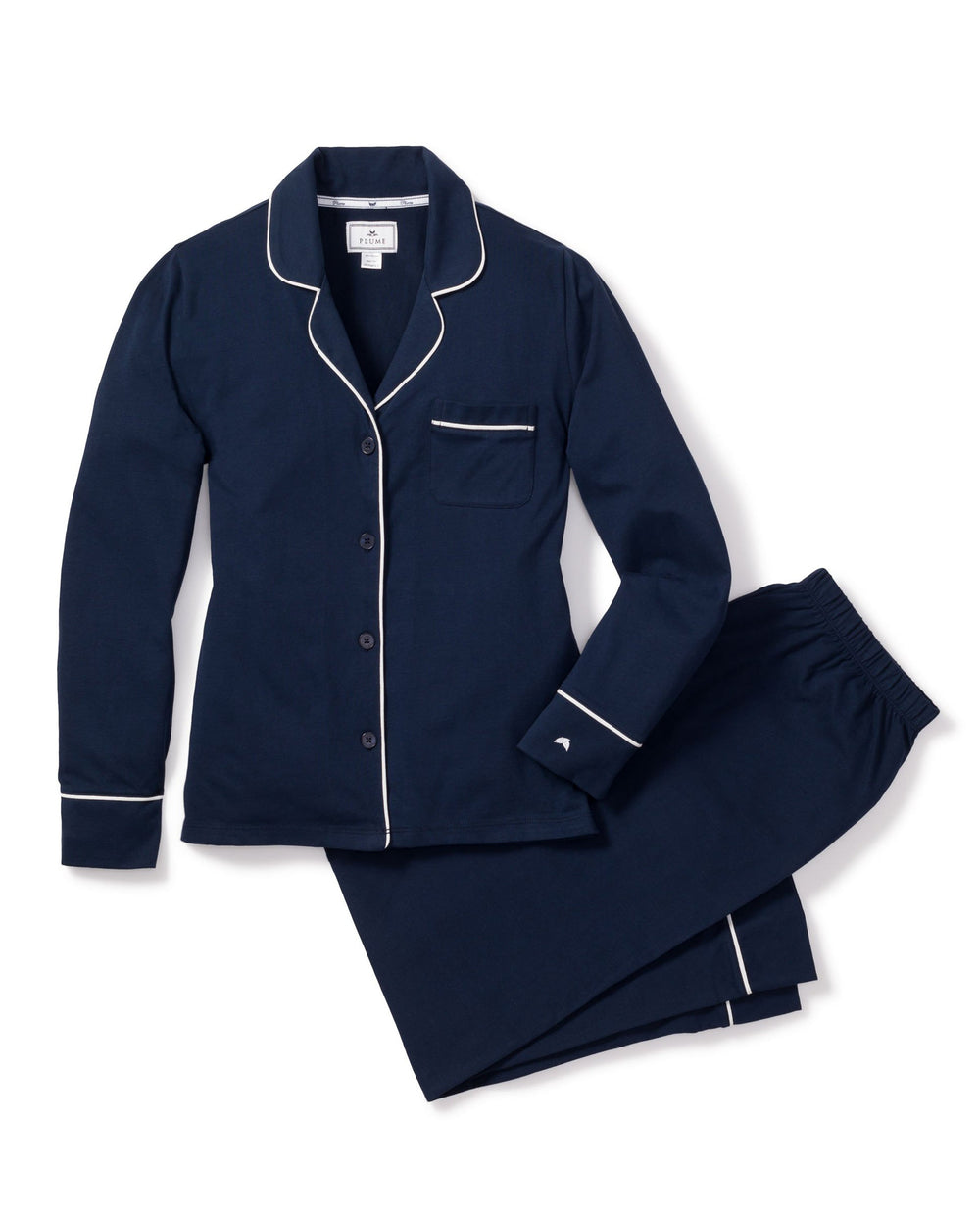 Navy blue pajama set with white piping on a white background