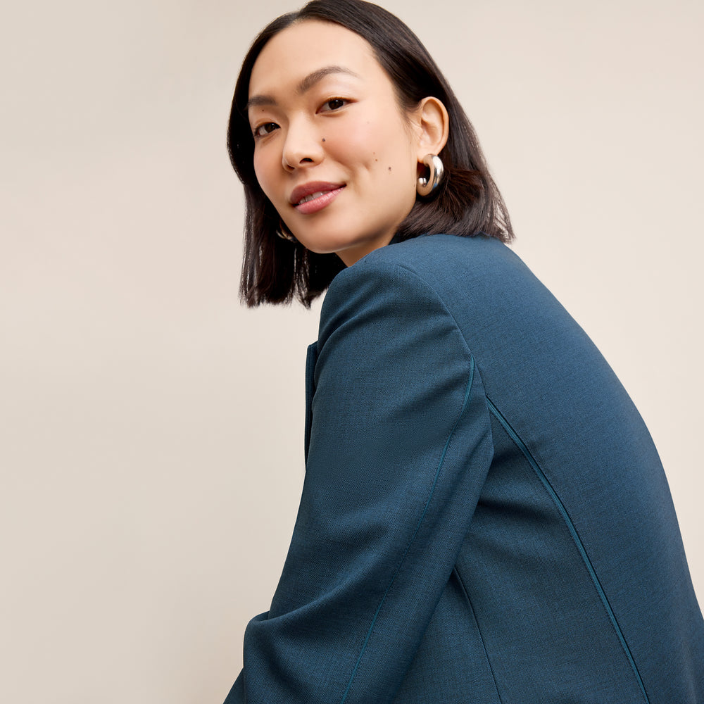 side image of a woman wearing the rossi jacket in bluebell