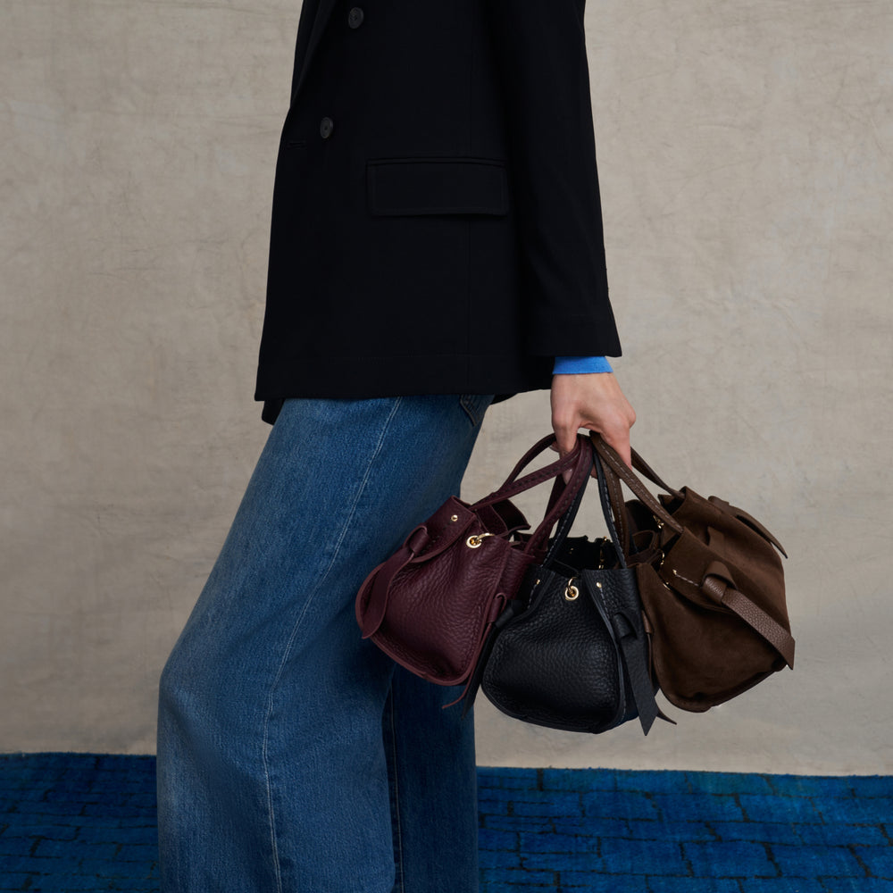 image of a woman holding several visona bags