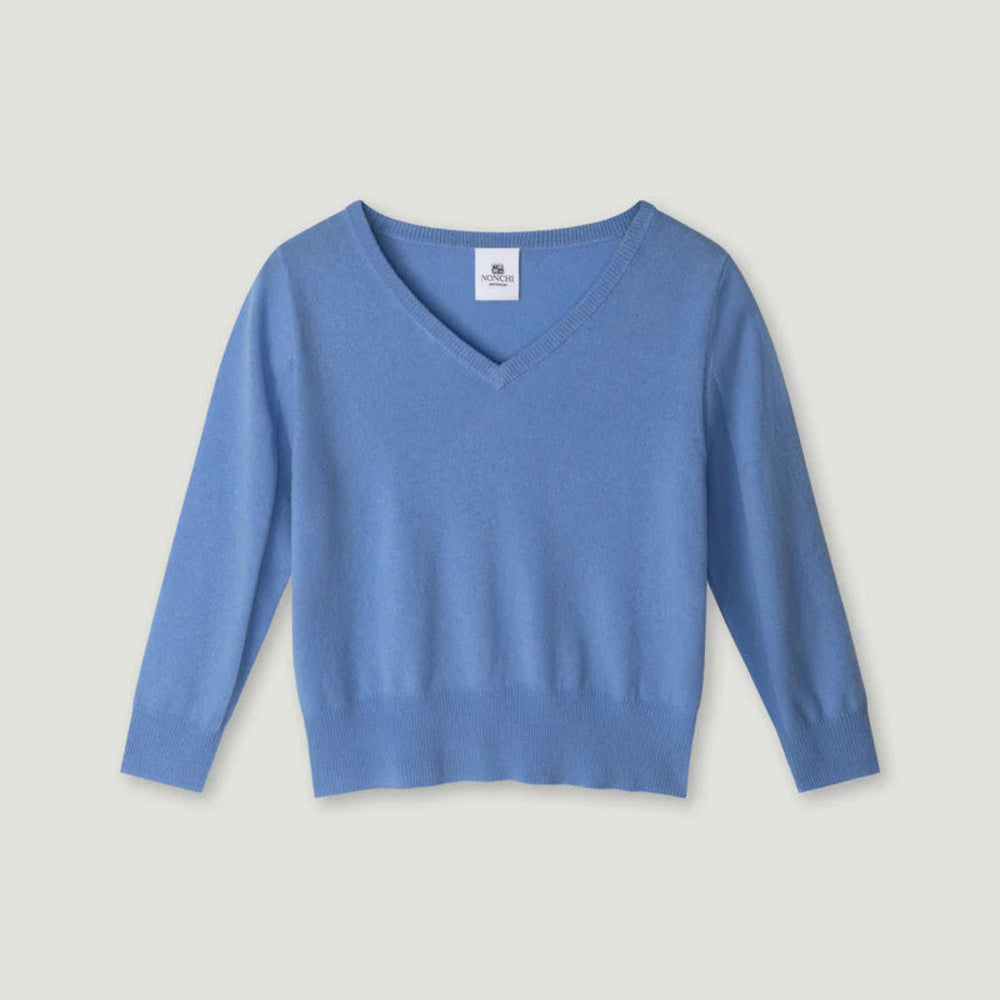 Blue sweater on a light gray background.