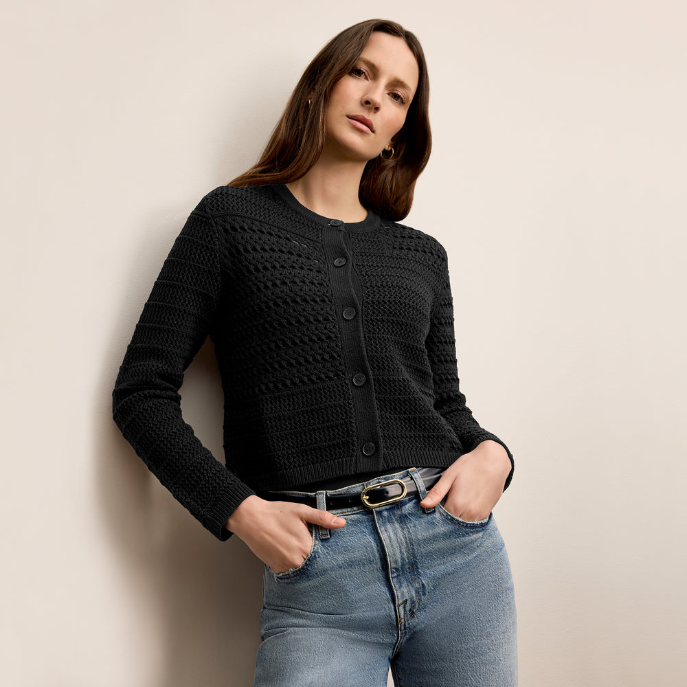 Front image of a woman wearing the zosia cardigan in black