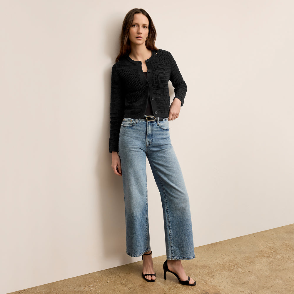 Front image of a woman wearing the zosia cardigan in black