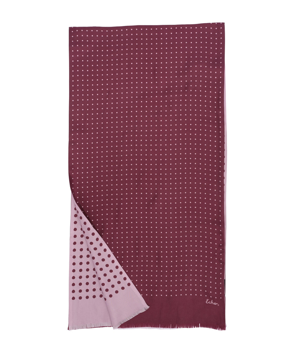 Burgundy scarf with polka dot pattern on a white background