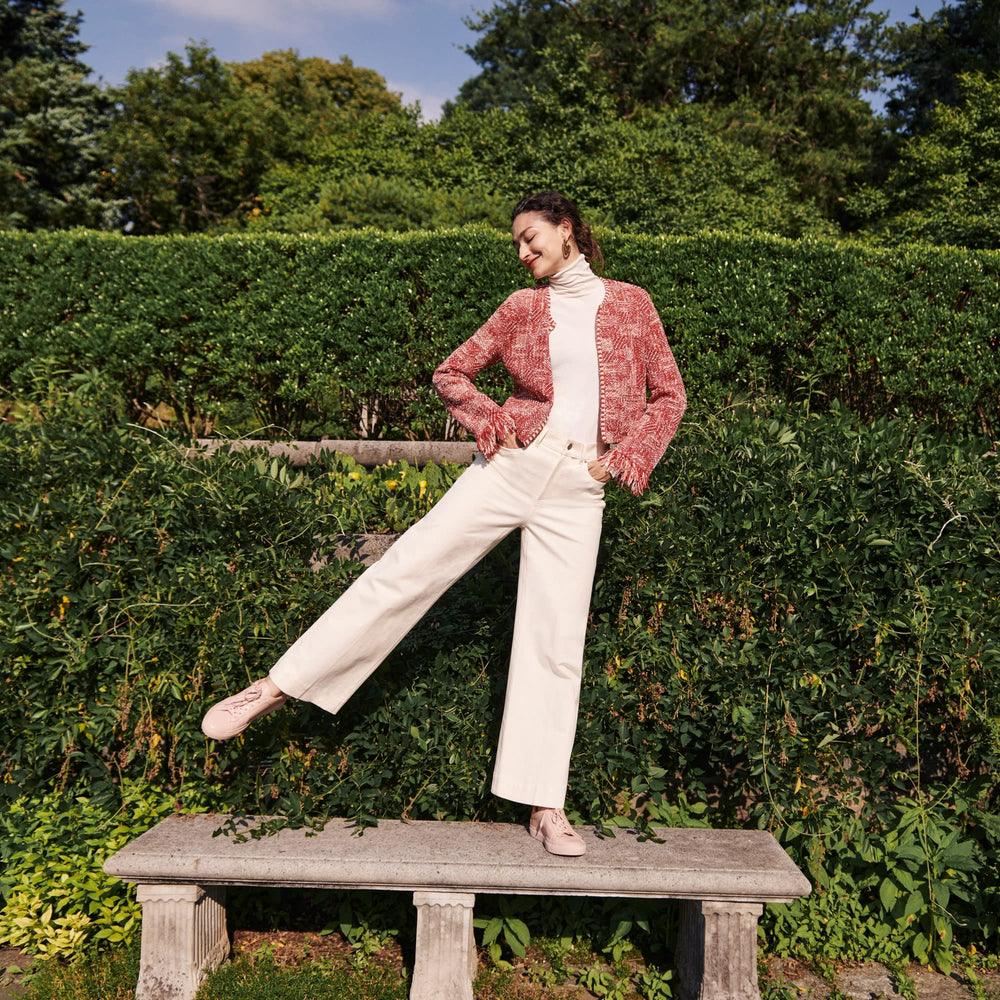 Front image of a woman standing wearing the Lilia Jacket—Interweave in Red Multi